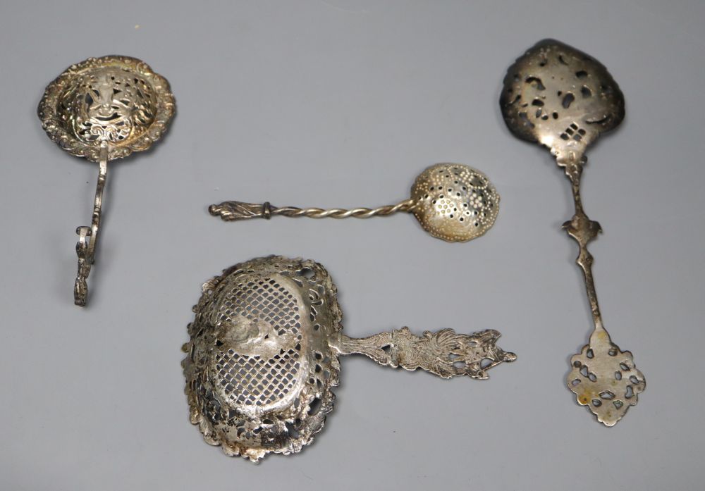 A Dutch oval silver tea caddy, embossed with cherubs and scrolls, 1893 import marks and four sifter spoons, various 5.5oz (caddy)